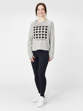 Woman wearing a pickleball sweatshirts with heart decorations